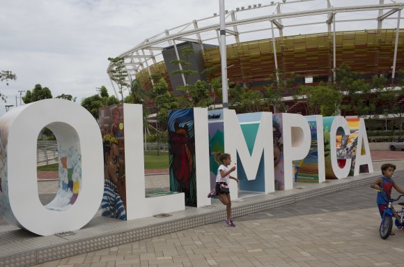 In this Feb.4, 2017 photo, children play near the Olympic Park sign in Rio de Janeiro, Brazil. Rio organizers still owe creditors about $40 million. (AP Photo/Silvia Izquierdo)
