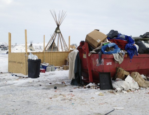 Trash is seen piled in a dumpster at an encampment set up near Cannon Ball, N.D., Wednesday, Feb. 8, 2017, for opponents against the construction of the Dakota Access pipeline. Opponents have called for protests around the world Wednesday, Feb. 8, 2017, as the Army prepared to green-light the final stage of the $3.8 billion project's construction. The Army said Tuesday, Feb. 7, that it will allow the four-state pipeline to cross under a Missouri River reservoir in North Dakota, the last big chunk of construction. (AP Photo/James MacPherson)
