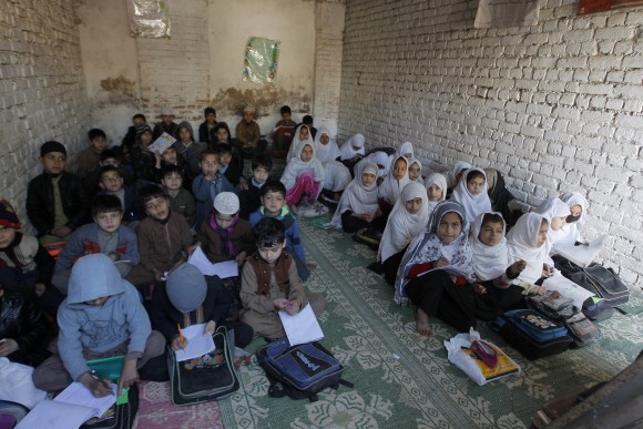 Afghan refugee children study at a school in Peshawar, Pakistan, on Feb. 9, 2017. (AP Photo/Mohammad Sajjad)