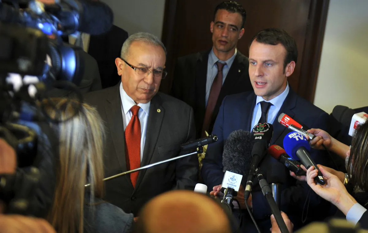 French Presidential candidate Emmanuel Macron, right, answers reporters with Algerian Foreign Minister Ramtane Lamamra in Algiers on Feb. 13, 2017. Claims made by Macron's campaign chairman Richard Ferrand Monday, assert that Russian groups are interfering with his presidential campaign but have offered little evidence to back up the claim. (AP Photo/Anis Belghoul)