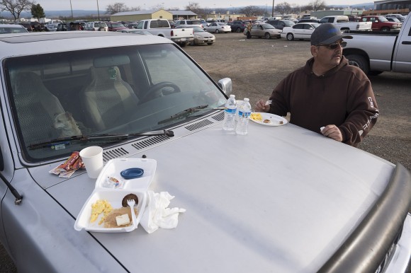 Todd Remocal of Biggs, Calif., eats breakfast on the hood of his truck at the Silver Dollar Fairgrounds on Monday, Feb. 13, 2017, in Chico, Calif. He and his wife Kelly slept in their vehicle with their three dogs last night after residents were evacuated from the area due to fears of a possible failure of the emergency spillway at the Oroville Dam.(Paul Kitagaki Jr./The Sacramento Bee via AP)