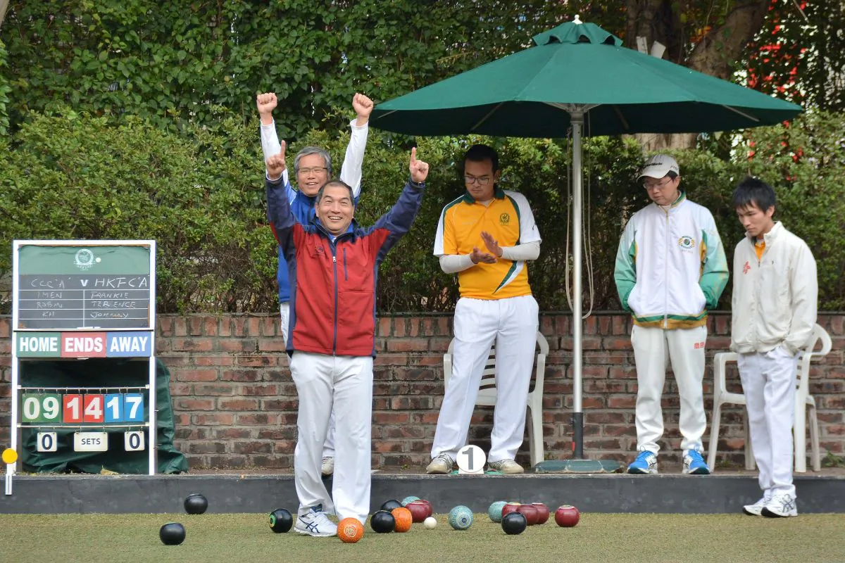Terrence Lee (red jacket) of Hong Kong Football Club celebrates a great shot from his skipper Johnny Tsang (not in photo). His team defeated CCC’s Lee Ka Ho 11-18 in the HKLBA Triples League on Saturday Feb 11, 2017 but was not enough to stop CCC winning the overall result 6:2. (Stephanie Worth)