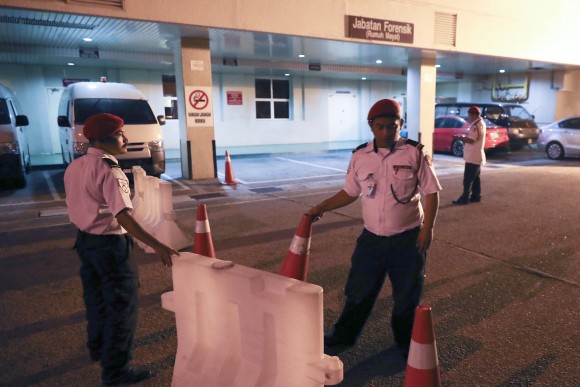 Hospital security personnel block the entrance of the Forensic department at the hospital, in Putrajaya, Malaysia on Feb. 14, 2017. (AP Photo/Vincent Thian)