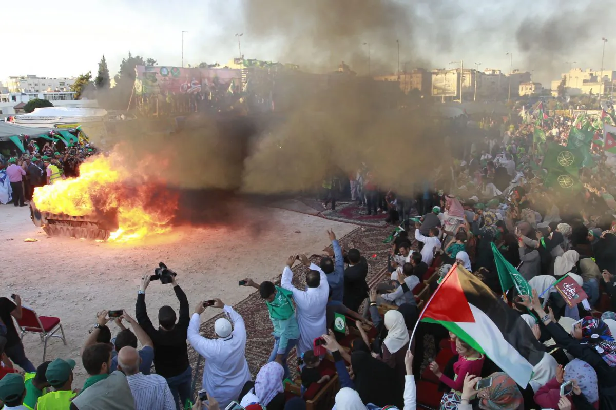 Jordanian supporters of the Muslim Brotherhood set fire to a mock Israeli tank during a protest to celebrate the 'Gaza victory' in the war against Israel, in the capital Amman on Aug. 8, 2014. (KHALIL MAZRAAWI/AFP/Getty Images)