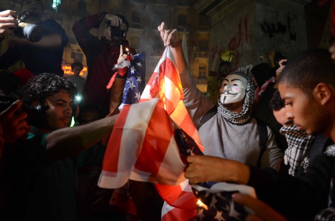 Supporters of the Muslim Brotherhood burn the American flag in a protest against the Egyptian military in Cairo on Jan. 22, 2014. (AHMED GAMEL/AFP/Getty Images)