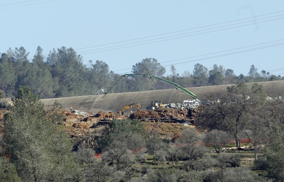 Repair crews work to repair the Oroville Dam's emergency spillway, Tuesday, Feb. 14, 2017, in Oroville, Calif. The barrier, at the nation's tallest dam, is being repaired after authorities ordered mass evacuations for everyone living below the lake out of concerns the spillway could fail and send a 30-foot wall of water roaring downstream. (AP Photo/Rich Pedroncelli)