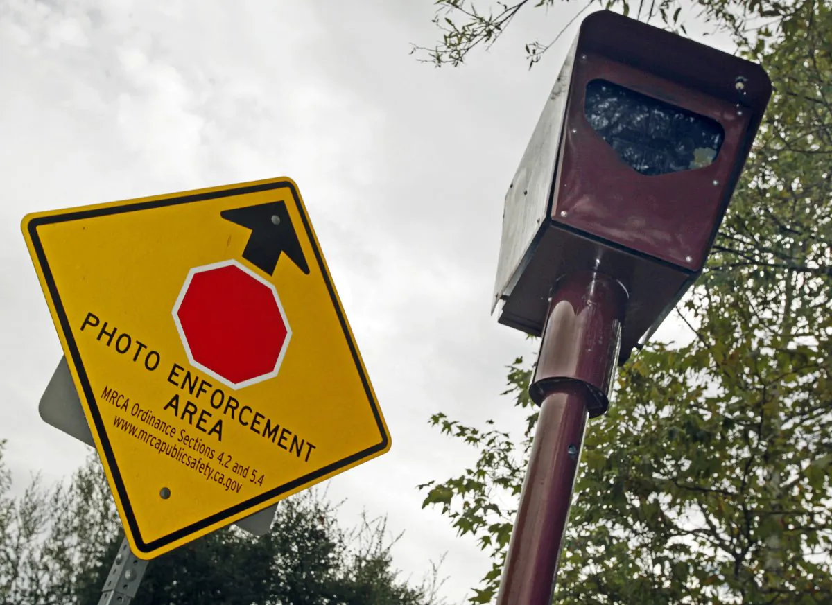 FILE - This Sept. 28, 2010 file photo shows a stop sign camera at the Top Of Topanga overlook in Topanga, Calif. Well over half of drivers in every age group have texted behind the wheel, run a red light or driven faster than the speed limit in the last 30 days, according to a new study released on Wednesday, Feb. 15, 2017, by the AAA Foundation for Traffic Safety. (AP Photo/Reed Saxon)