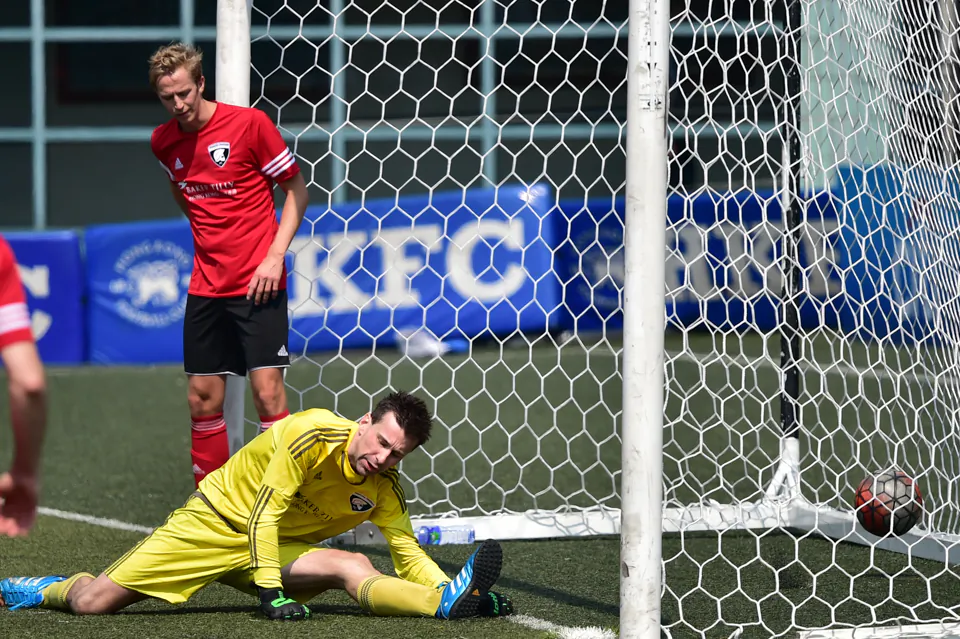 Baker Tilly Spartans' goalie is unable to stop this shot by Albion striker to give Albion a 2-0 lead in their Yau Yee League match at Sports Road on Sunday Feb 12, 2017. Albion went on to win the game 3-0. (Bill Cox/Epoch Times)