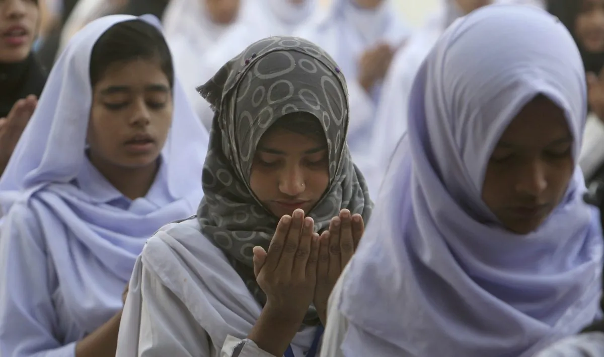 Pakistani students pray for victims of Thursday's suicide bombing at the Lal Shahbaz Qalandar shrine, on Feb. 17, 2017 (AP Photo/Fareed Khan)