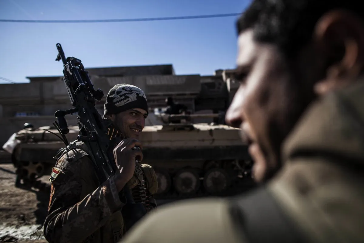 An Iraqi soldier from the 9th Infantry Division holds his machine gun while heading to the frontline in Shyma district in Mosul, Iraq in this Dec. 6, 2016 file photo. Iraqi forces, backed the U.S.-led international coalition, launched a campaign in October to retake Mosul, the country's second largest city and ISIS's last major urban bastion in Iraq. (AP Photo/Manu Brabo, File)