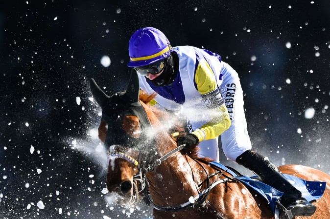 Fabris Jindrich with his horse Hello Goodby competes during the flat race of the White Turf horse racing event in St. Moritz, Switzerland, on Feb. 19, 2017. The races are held on the frozen lake of the Swiss mountain resort. (MICHAEL BUHOLZER/AFP/Getty Images)
