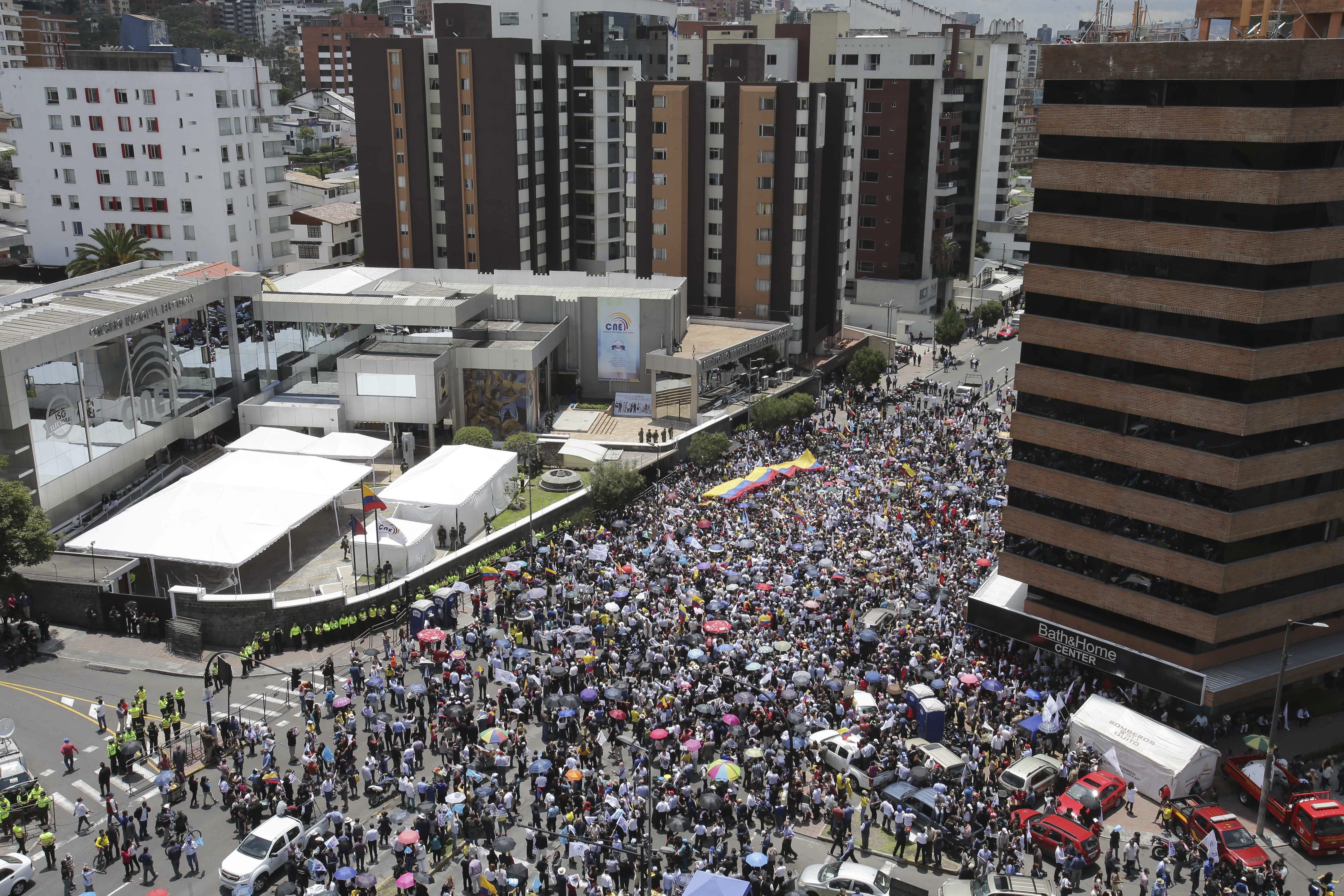 Opposition presidential candidate Guillermo Lasso's supporters protest outside Ecuador's National Electoral Council to demand the official results of the presidential elections, in Quito, Ecuador on Feb. 20, 2017. (AP Photo/Dolores Ochoa)