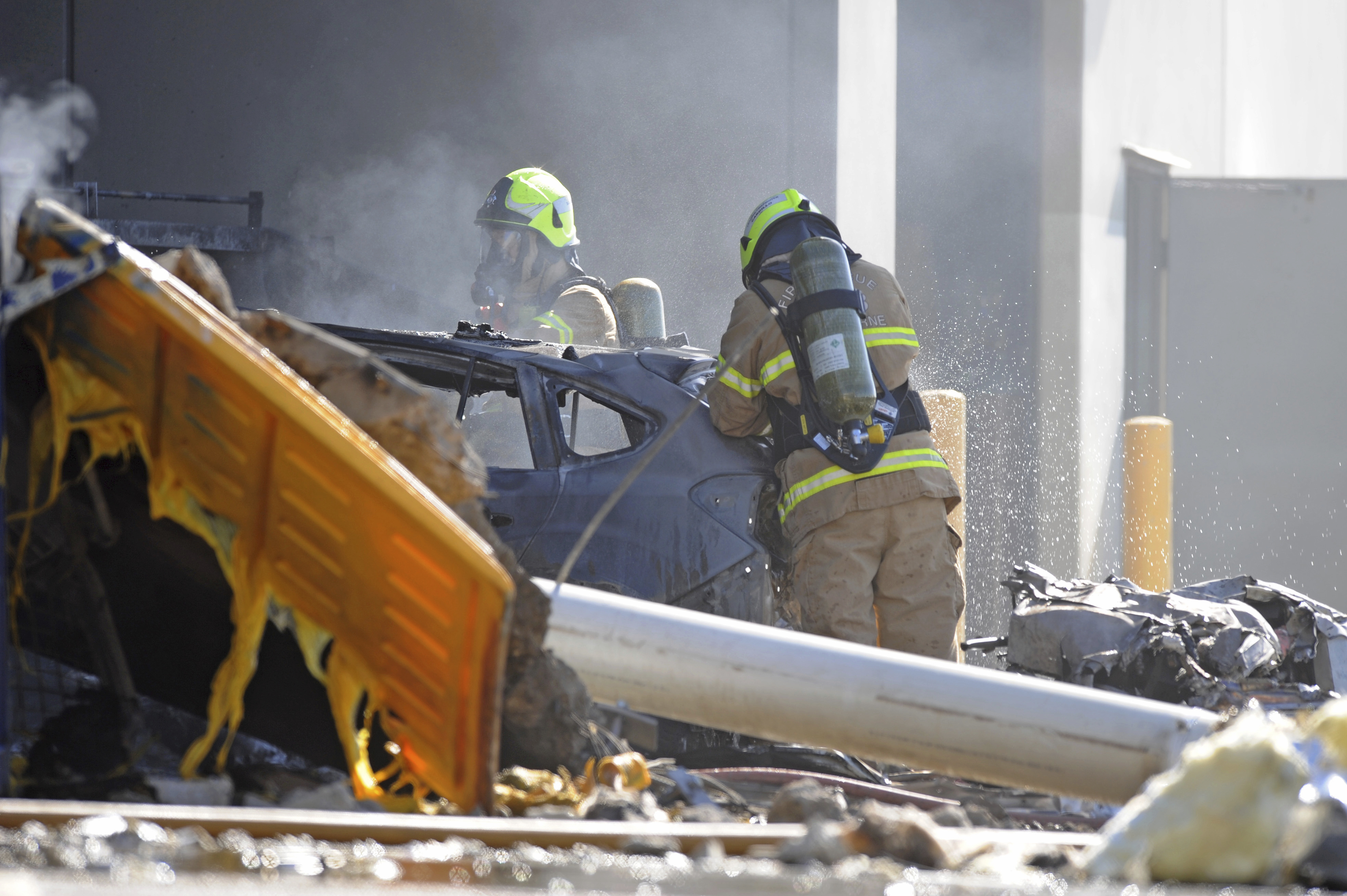 Emergency personnel work at a light plane crashed in Melbourne, Australia on Feb. 21, 2017. (Joe Castro/AAP Image via AP)