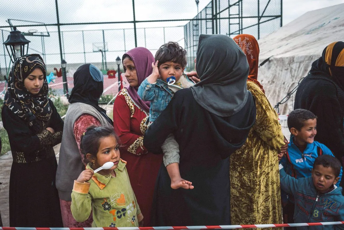 Civilians displaced by heavy fighting between Iraqi security forces and ISIS terrorists line up outside a medical aid tent in Makhmour, Iraq, on March 28, 2016. (AP Photo/Alice Martins)