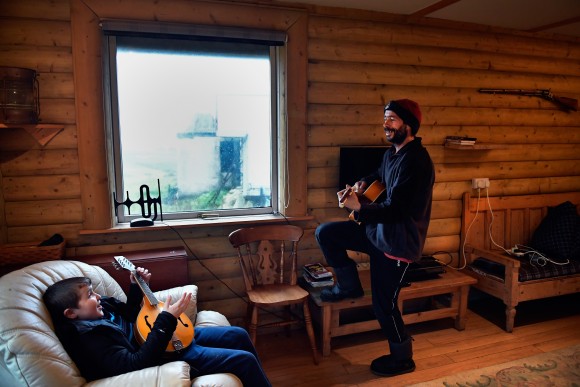 FOULA, SCOTLAND - SEPTEMBER 28: Stuart Taylor and Jack Smith the only school child on the Island of Foula,enjoy a quick tune on the guitar and mandolin on September 28, 2016 in Foula, Scotland. ( Jeff J Mitchell/Getty Images)