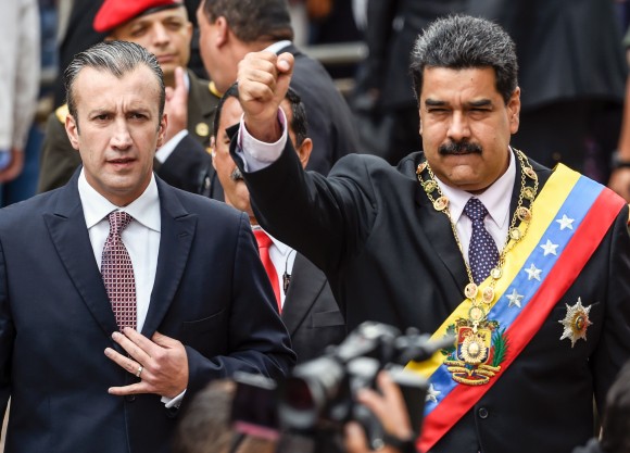 Venezuelan President Nicolas Maduro (R) and Vicepresident Tareck El Aissami greet supporters before the ceremony where Maduro gave a speech reviewing his year in office at the Supreme Court of Justice in Caracas on Jan. 15, 2017. (JUAN BARRETO/AFP/Getty Images)