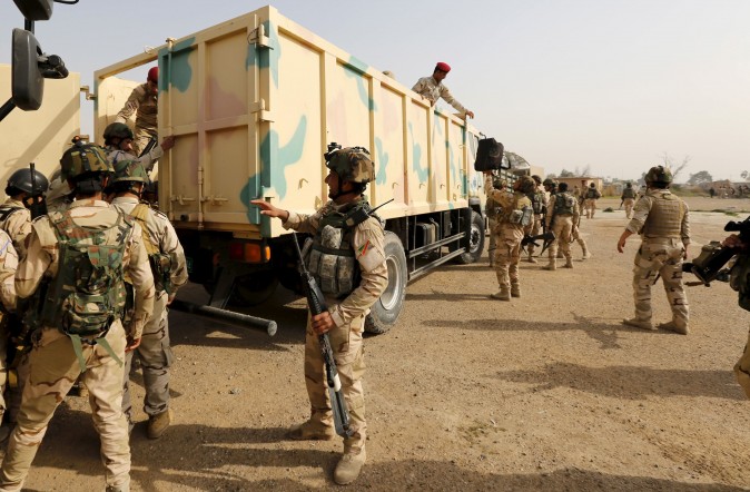 Iraqi security forces climb into trucks travelling to Mosul to fight against ISIS terrorists at an Iraqi army base in Camp Taji, Baghdad, on Feb. 21, 2016. (REUTERS/Ahmed Saad)