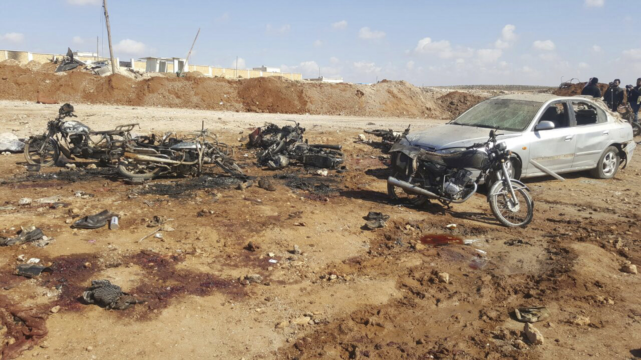 Burned motorcycles and car damaged after a suicide attacker blew his small pick-up truck outside a security office in Sousian village, about 8 kilometers (5 miles) north of al-Bab, Syria on Feb. 24, 2017. (Thiqa News Agency, via AP)