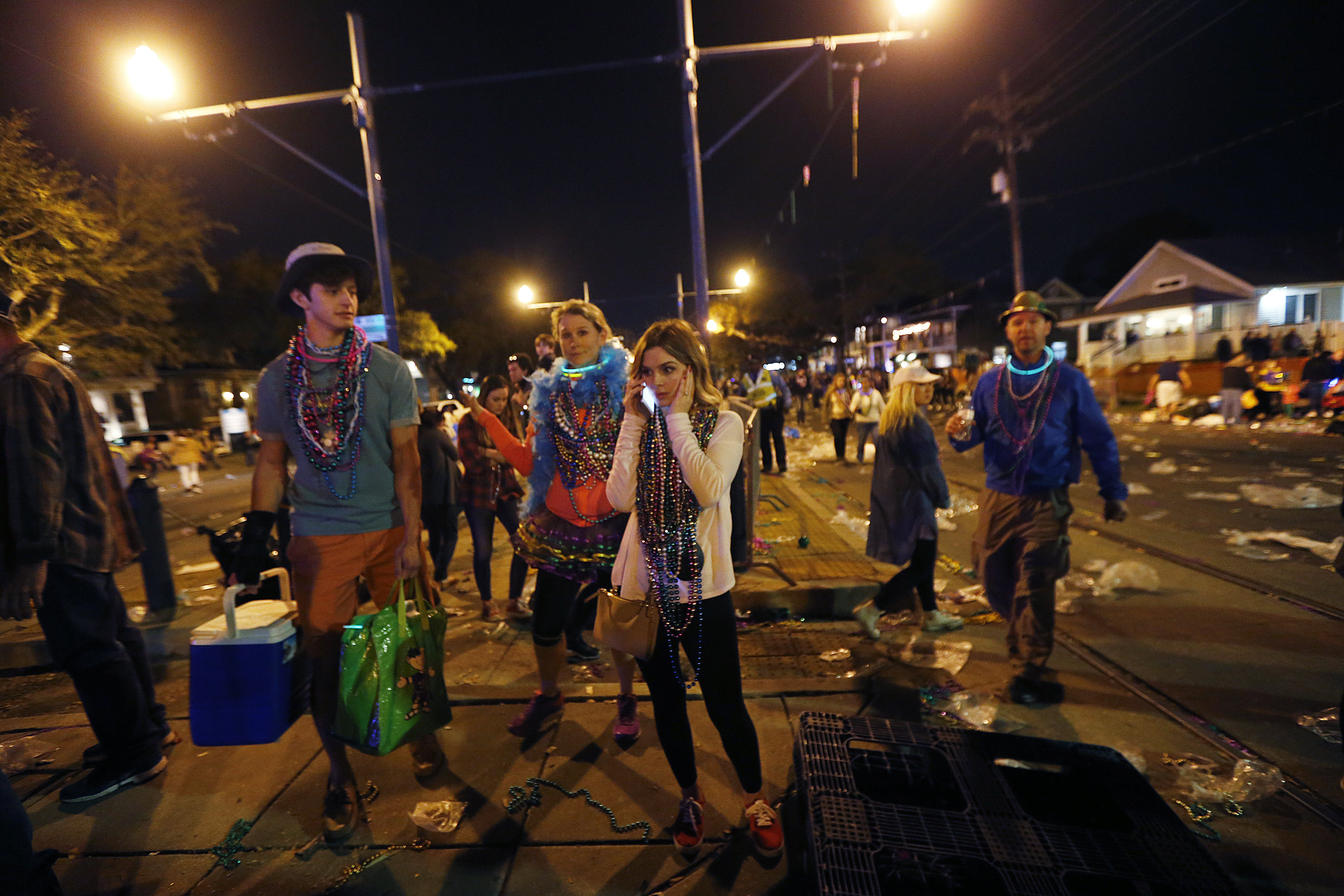 A woman talks on a phone at the scene of where a truck slammed into a crowd and other vehicles, causing multiple injuries, during the Krewe of Endymion parade in New Orleans on Feb. 25, 2017. (AP Photo/Gerald Herbert)