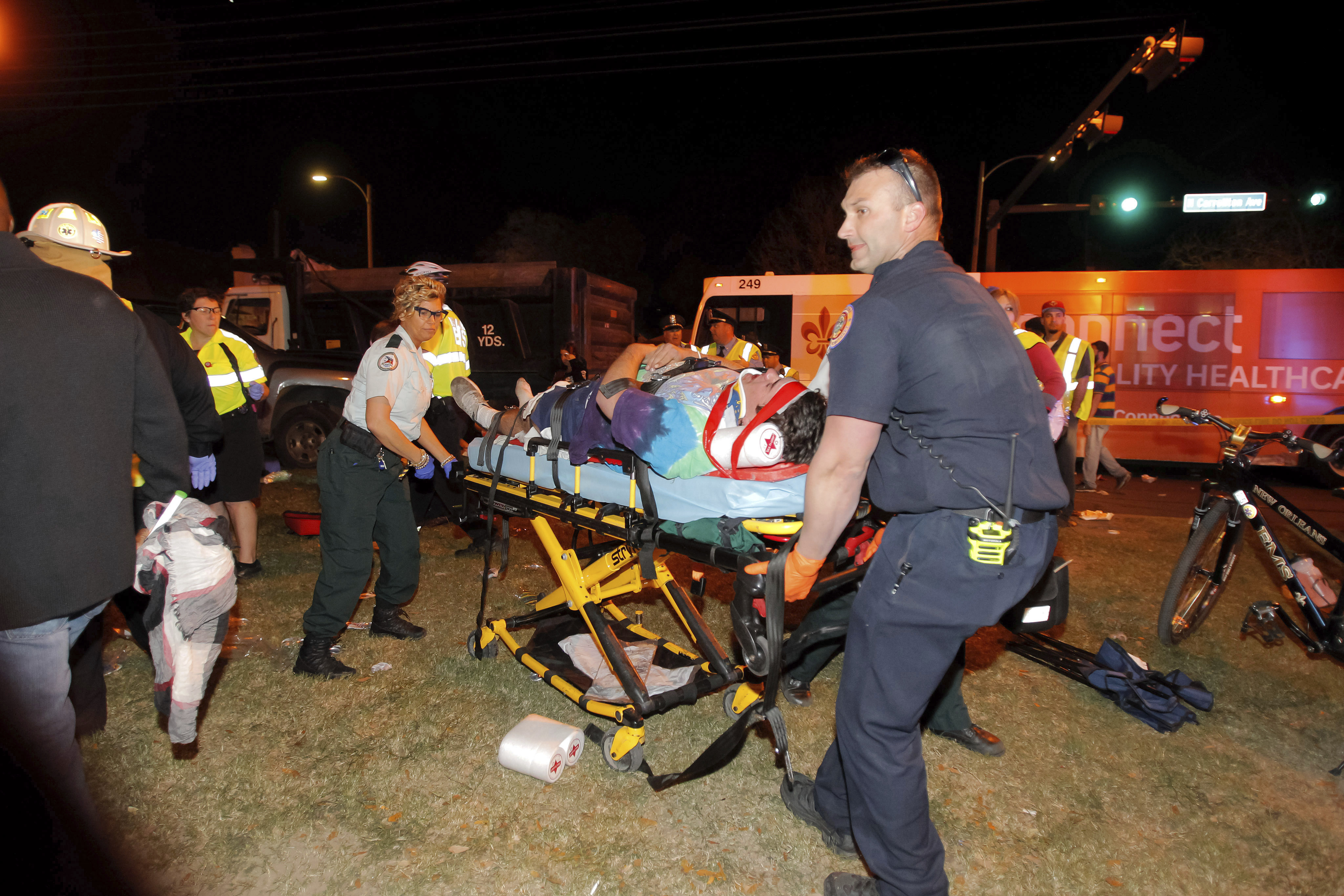 New Orleans emergency personnel attend to an injured parade watcher after a pickup truck plowed into a crowd injuring multiple people watching the Krewe of Endymion parade in the Mid-City section of New Orleans on Feb. 25, 2017. (Scott Threlkeld/The Advocate via AP)