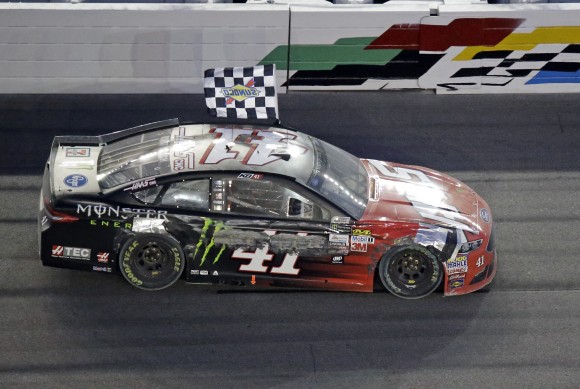 Kurt Busch drives in front of the ran stand waving the checkerd flag after winning the Daytona 500 auto race at Daytona International Speedway on Feb. 26, 2017, in Daytona Beach, Fla. (AP Photo/John Raoux)