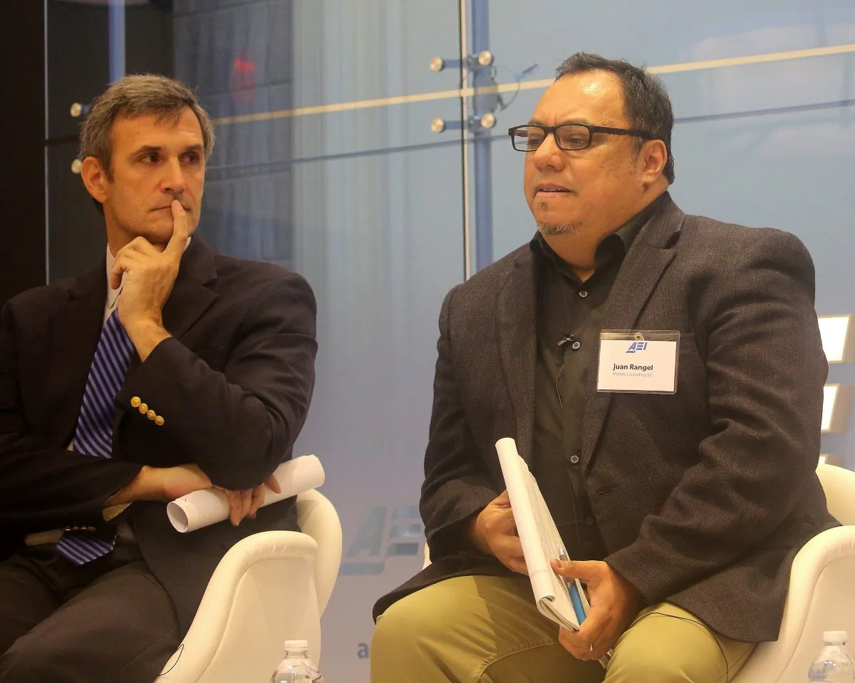 Juan Rangel, former CEO of the United Neighborhood Organization and founder of Chicago’s Octavio Paz Charter School, speaks at the American Enterprise Institute, Feb. 22, on civic education for immigrants. To the left sits David Randall, National Association of Scholars, who also spoke on civic education in America. (Gary Feuerberg/ Epoch Times)