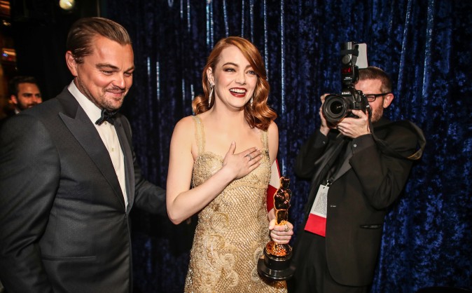 Leonardo DiCaprio walks out with Emma Stone who won Best Actress for 'La La Land' backstage during the 89th Annual Academy Awards in Hollywood, Calif., on Feb. 26. (Christopher Polk/Getty Images) 