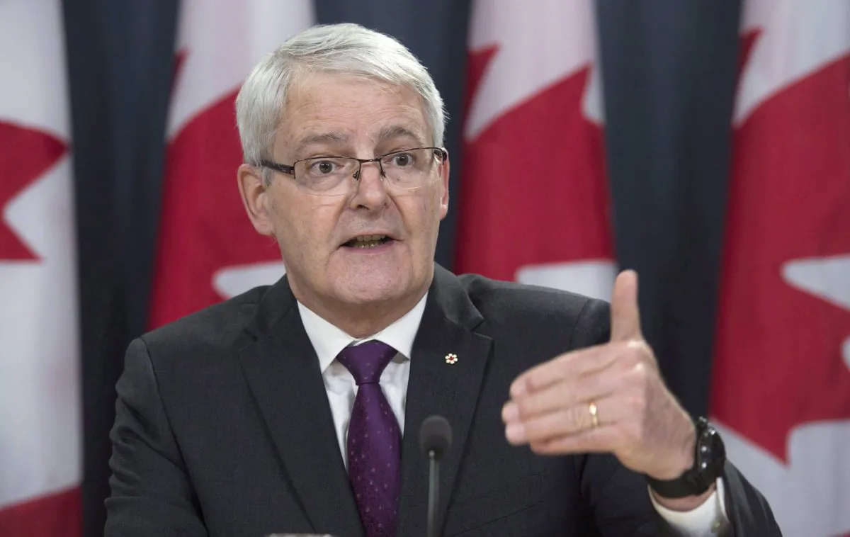 Minister of Transport Marc Garneau speaks at a news conference in Ottawa on Feb. 23, 2017. Garneau is proposing the creation of a tough national standard to penalize distracted drivers who use their cellphones on the road. (The Canadian Press/Adrian Wyld)