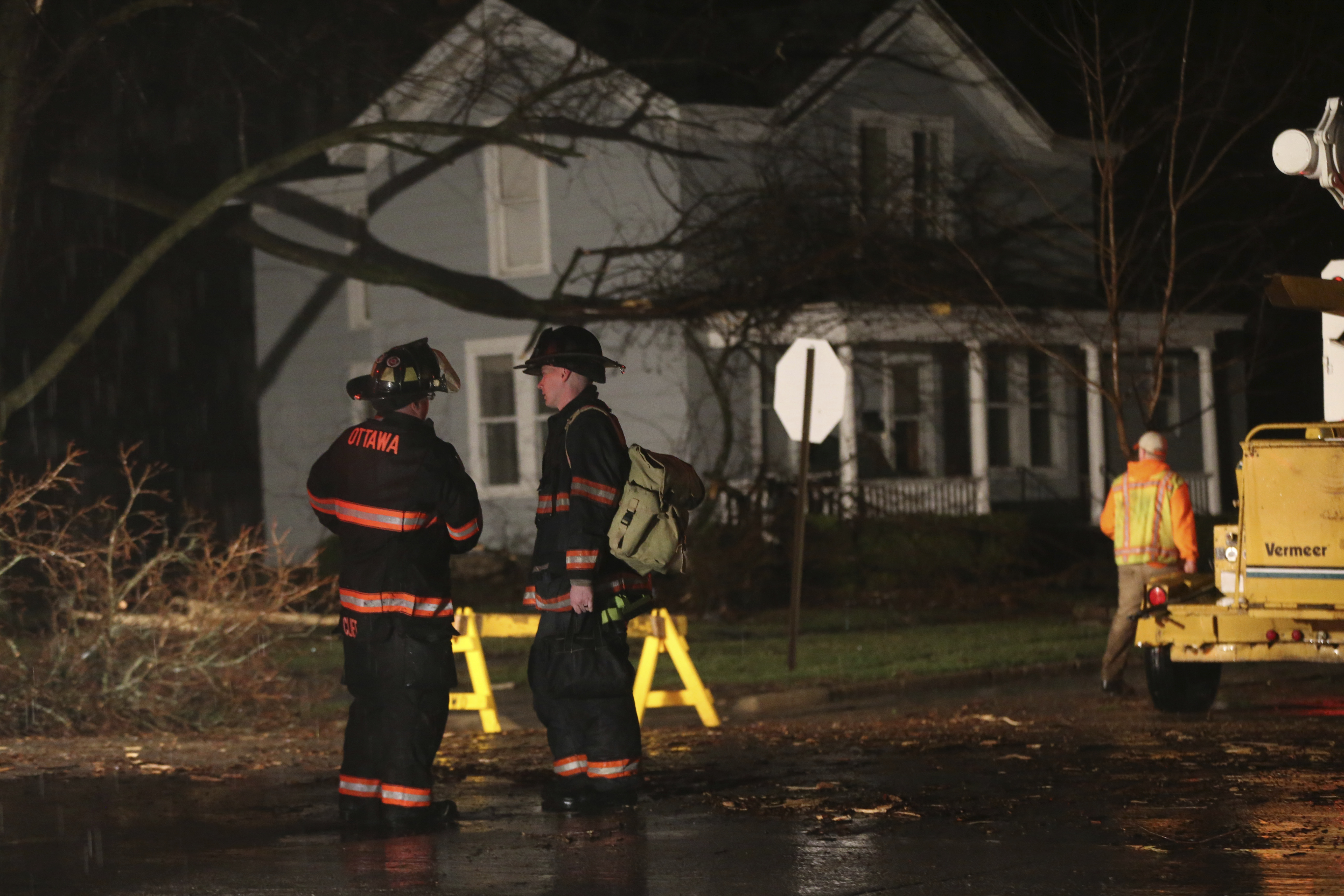 Firefighters stand near a home that was damaged during a storm in Ottawa, Ill., on Feb. 28, 2017. (Nuccio DiNuzzo/Chicago Tribune via AP)