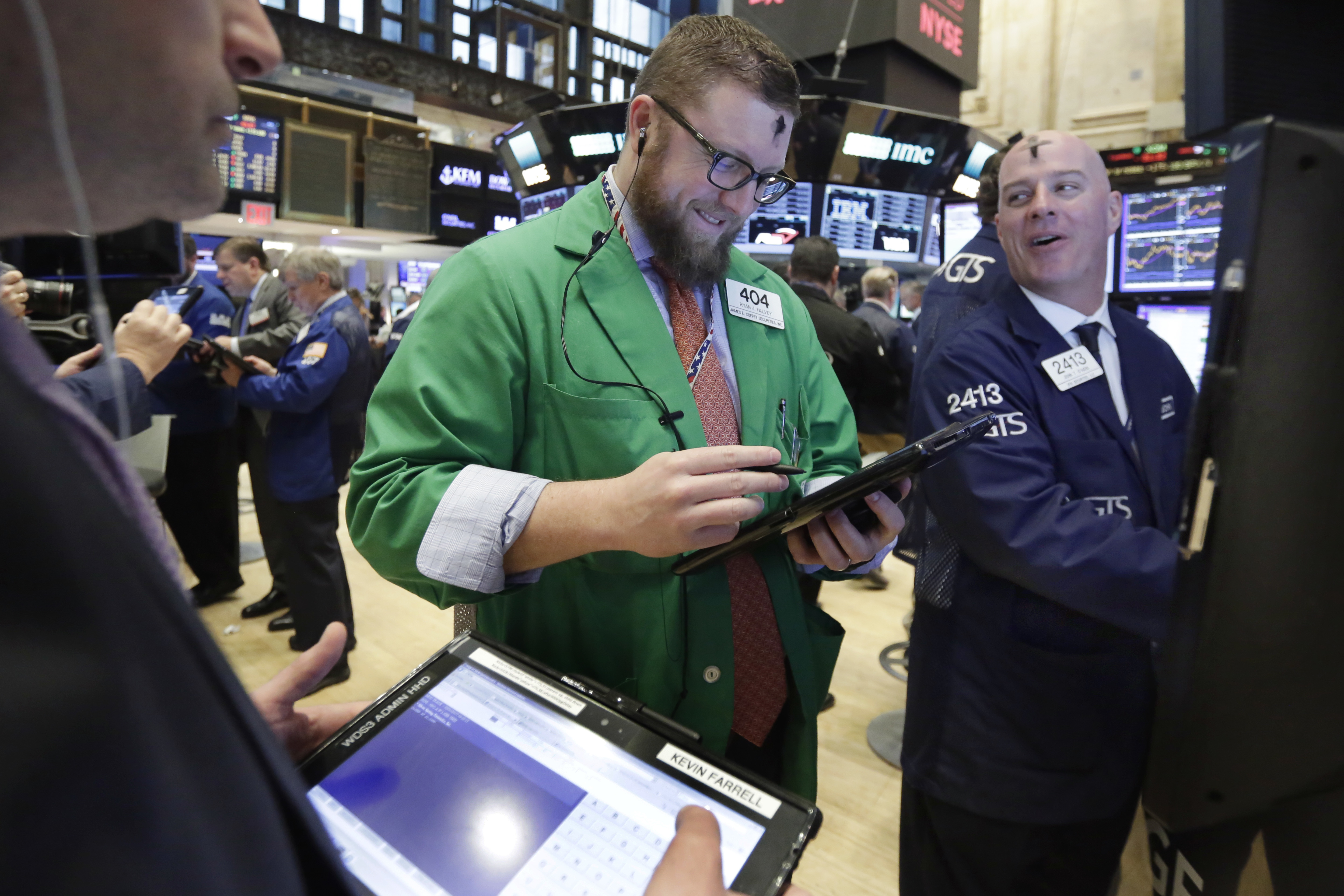 Trader Ryan Falvey, center, and specialist John O'Hara work on the floor of the New York Stock Exchange, Wednesday, March 1, 2017. Stocks opened strongly higher on Wall Street, led by big gains in banks as investors expected interest rates to rise. The early jump Wednesday put the Dow Jones industrial average above 21,000 points for the first time. (AP Photo/Richard Drew)