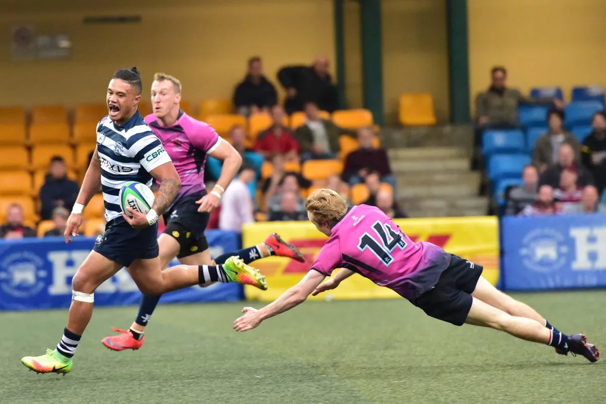 HKFC’s Nathan De Thierry makes a break for the HKCC line and looks certain to score, but was stopped one metre short by HKCC’s Alex McQueen (in red boots). (Bill Cox/Epoch Times)