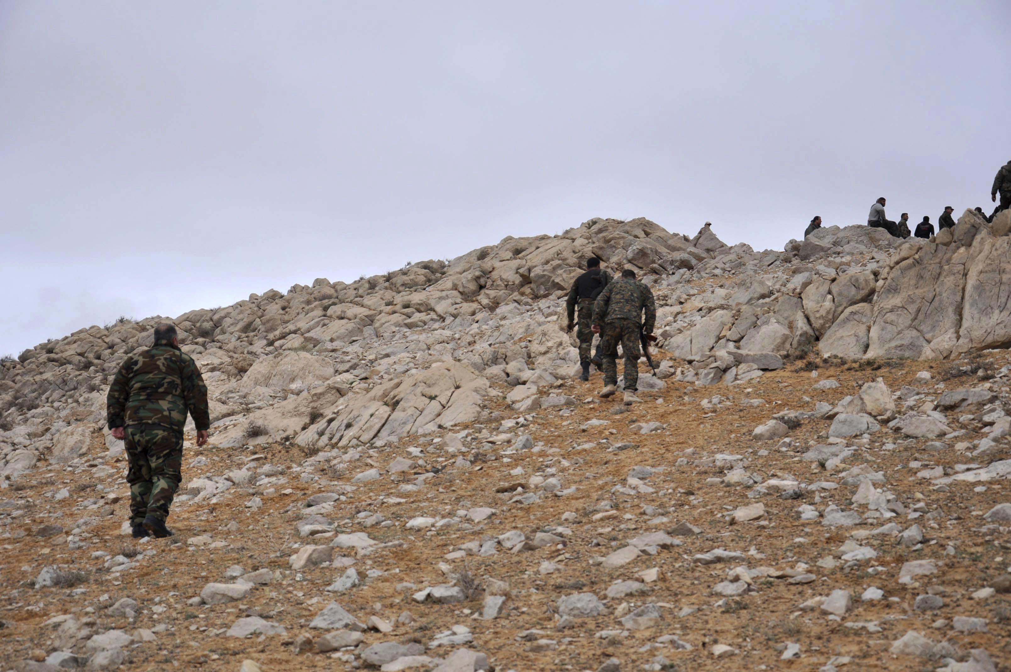 In this photo released by the Syrian official news agency SANA, Syrian forces take up positions during fighting between Government forces and ISIS terrorists in the ancient city of Palmyra, near Homs, Syria on March 2, 2017. (SANA via AP)
