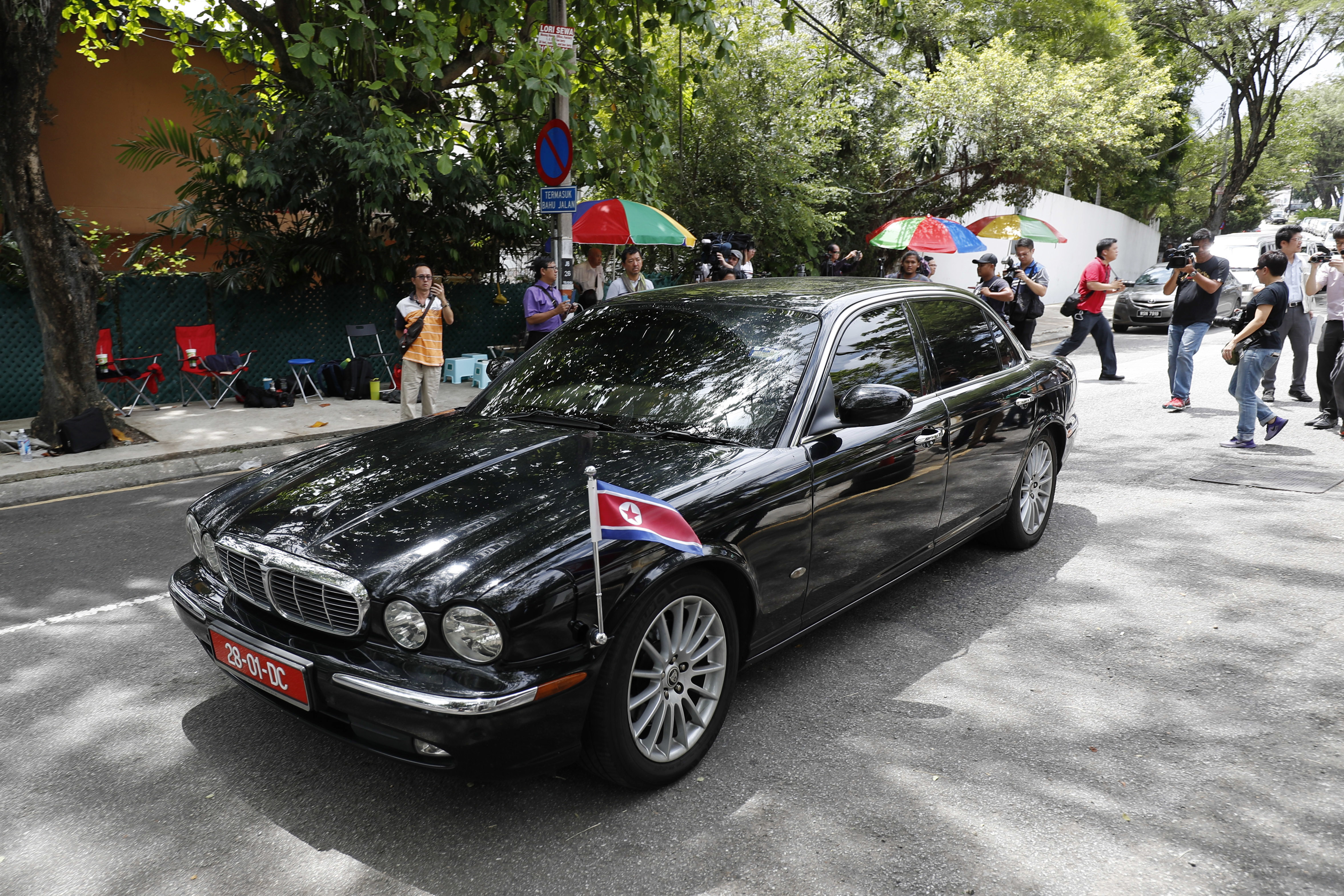 Journalists chase a North Korean diplomatic vehicle as it leaves the North Korean Embassy in Kuala Lumpur, Malaysia on March 3, 2017. (AP Photo/Vincent Thian)