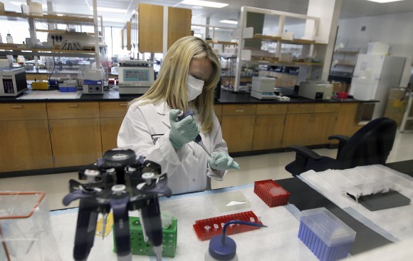 Senior Criminalist Heide Elliott works on extracting DNA at the State of California Department of Justice Jan Bashinski DNA Laboratory in Richmond, Calif. on Feb. 17, 2012 More police departments are amassing their own DNA databases, a move critics say is a way around stringent regulations governing state crime labs and the national DNA database. (AP Photo/Jeff Chiu, File)