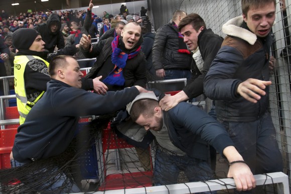 CSKA Moscow fans attack a Zenit fan (C) during the national championship soccer match between CSKA Moscow and Zenit in Moscow, Russia, on March 4, 2017. (AP Photo/Tikhon Danin)