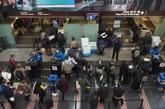 Travelers wait in line at a security screening checkpoint inside the airport terminal at Ronald Reagan Washington National Airport in Arlington, Virginia, on Dec. 22, 2016. (SAUL LOEB/AFP/Getty Images)