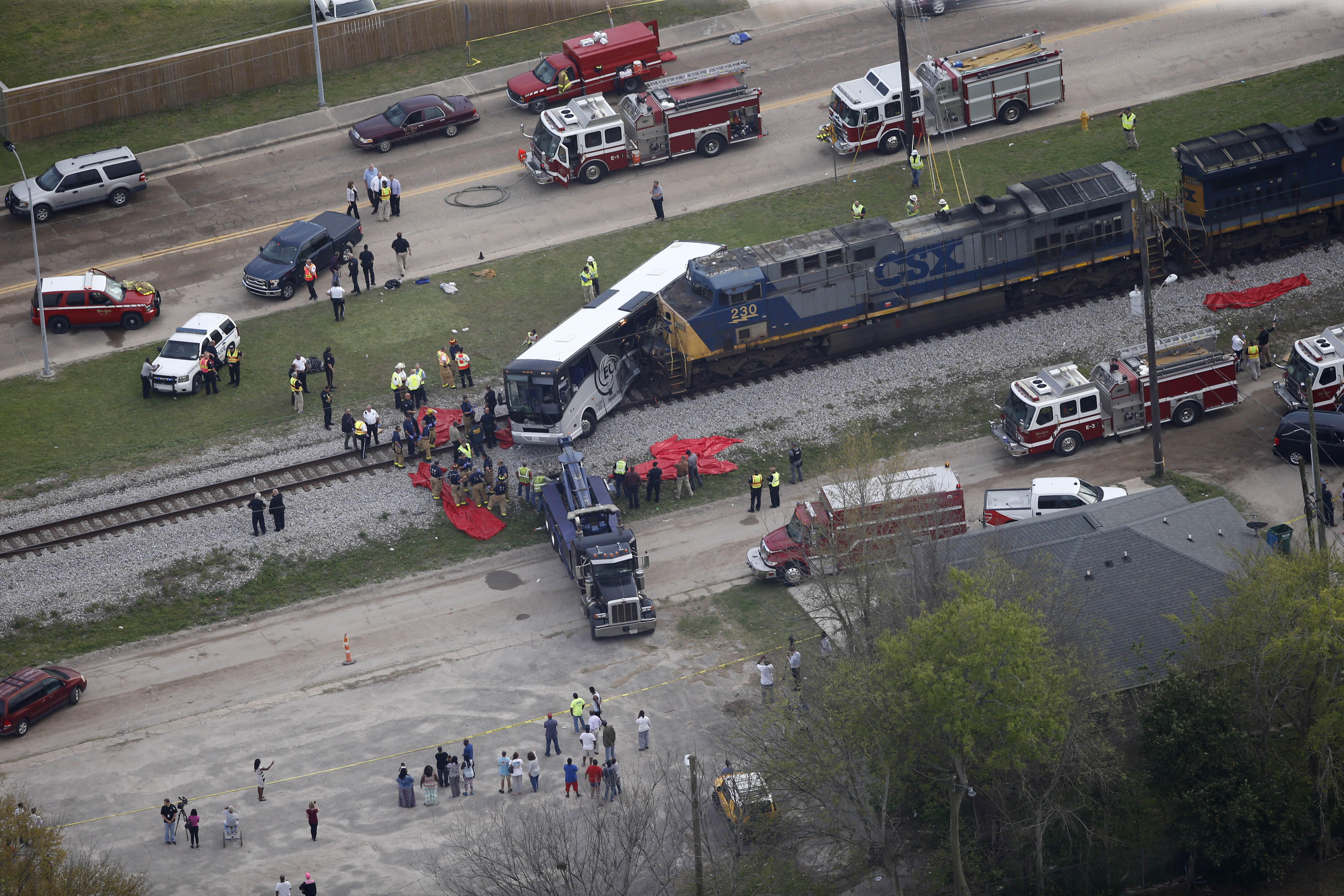 Responders works the scene where a train hit a bus in Biloxi, Miss., on March 7, 2017. (AP Photo/Gerald Herbert)