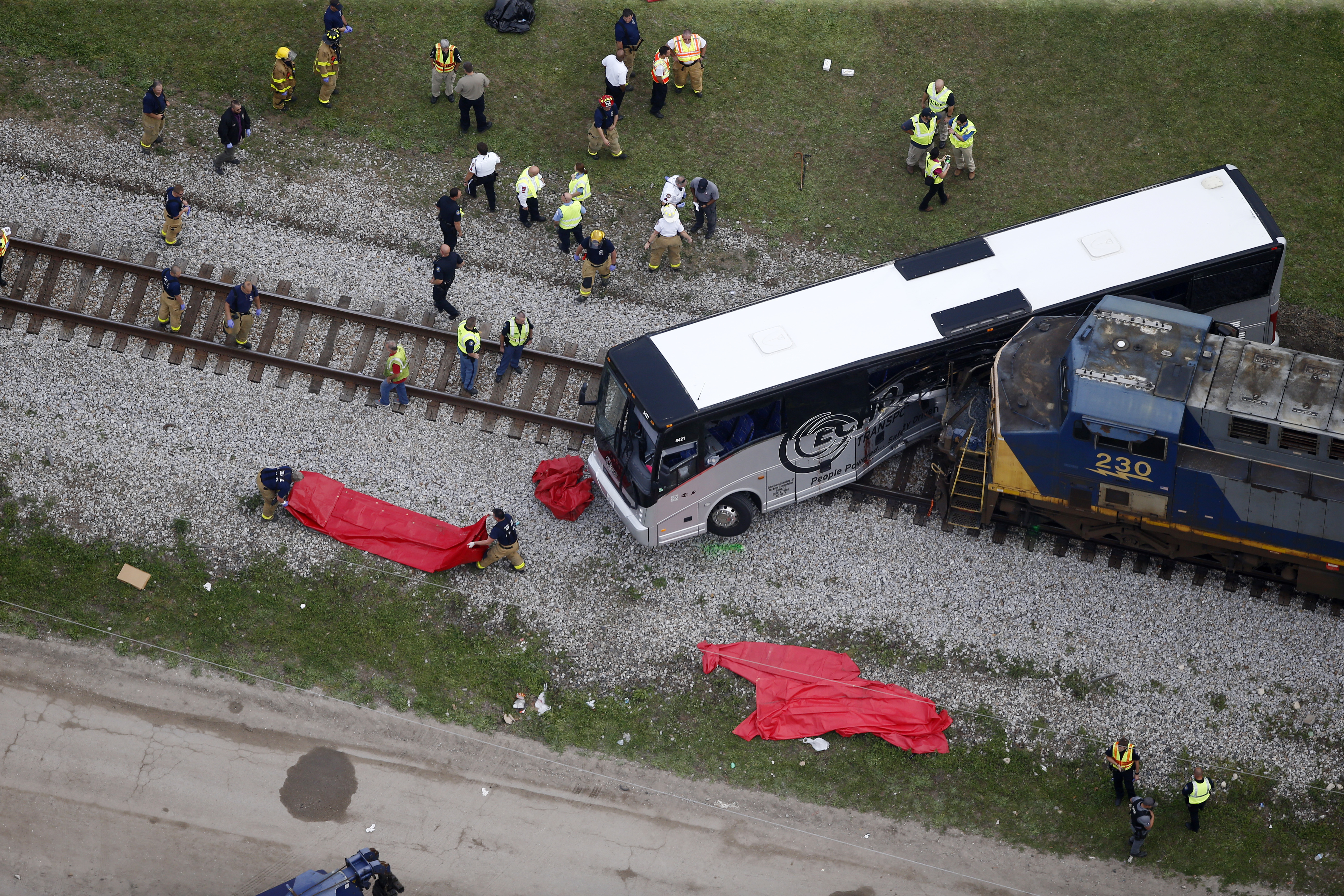 Responders works the scene where a train hit a bus in Biloxi, Miss., on March 7, 2017. (AP Photo/Gerald Herbert)