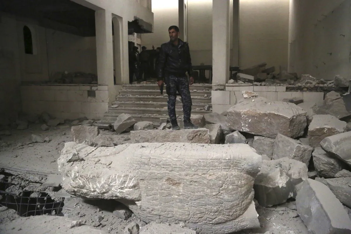 Iraqi federal police inspect the inside of Mosul's heavily damaged museum. (AP Photo/Khalid Mohammed)