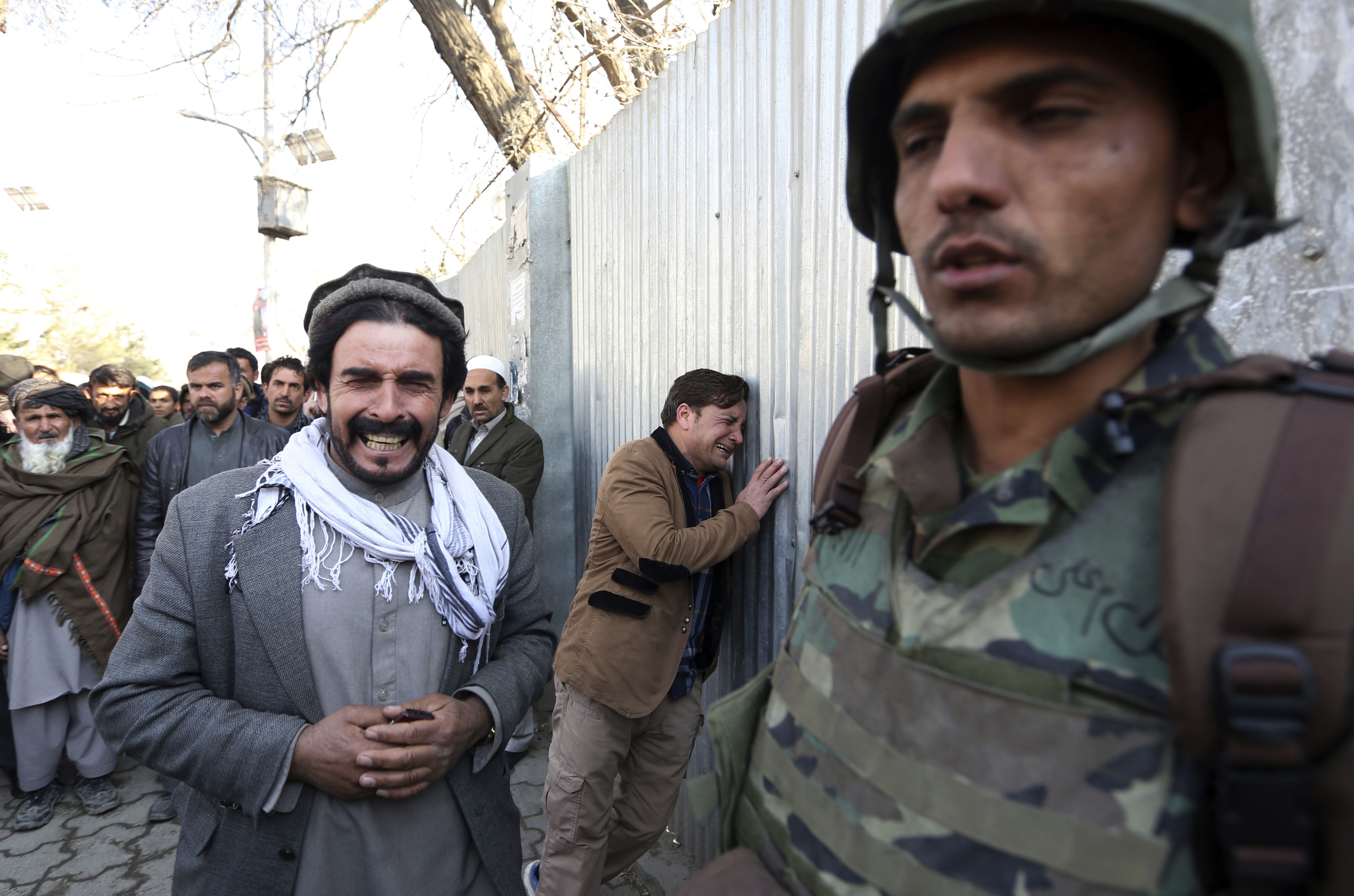 Afghans cry after an attack on a military hospital in Kabul, Afghanistan on March 8, 2017. (AP Photo/Rahmat Gul)