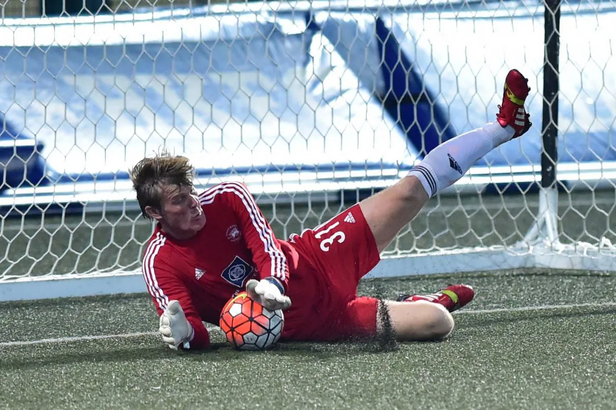 Club Albion’s goalie Rudi Hollaender Saves a penalty in their derby match against Club Colts in their Yau Yee League Division 1 match on Sunday March 5, 2017. Albion won the encounter 3-0. (Bill Cox/Epoch Times)