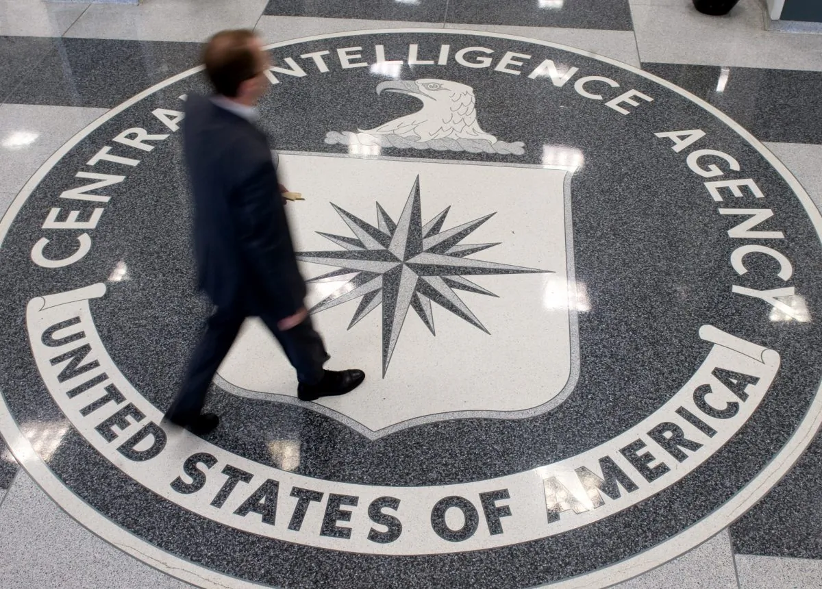 A man crosses the Central Intelligence Agency logo in the lobby of CIA Headquarters in Langley, Va., on Aug. 14, 2008. (SAUL LOEB/AFP/Getty Images)