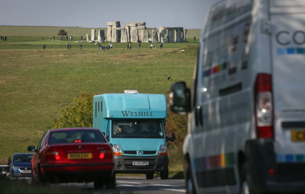 Traffic passes along the busy A303 that runs besides the ancient neolithic monument of Stonehenge in Wiltshire, England, on Oct. 13, 2015. The U.K. Government is planning to build a $2.4 billion tunnel under the UNESCO-listed ancient monument, but opponents say it risks unsettling ancient burial sites.(Matt Cardy/Getty Images)