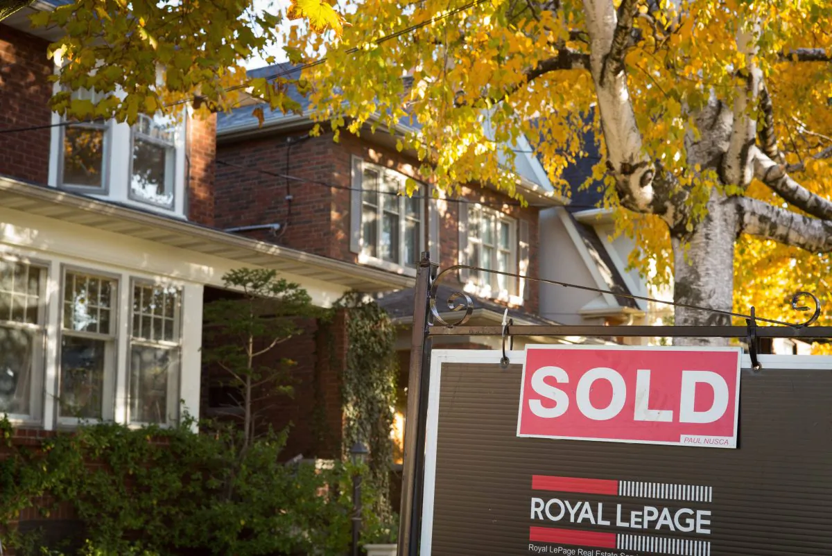 A real estate "sold" sign hangs in front of a west-end Toronto property on Nov. 4, 2016. (Graeme Roy/The Canadian Press)
