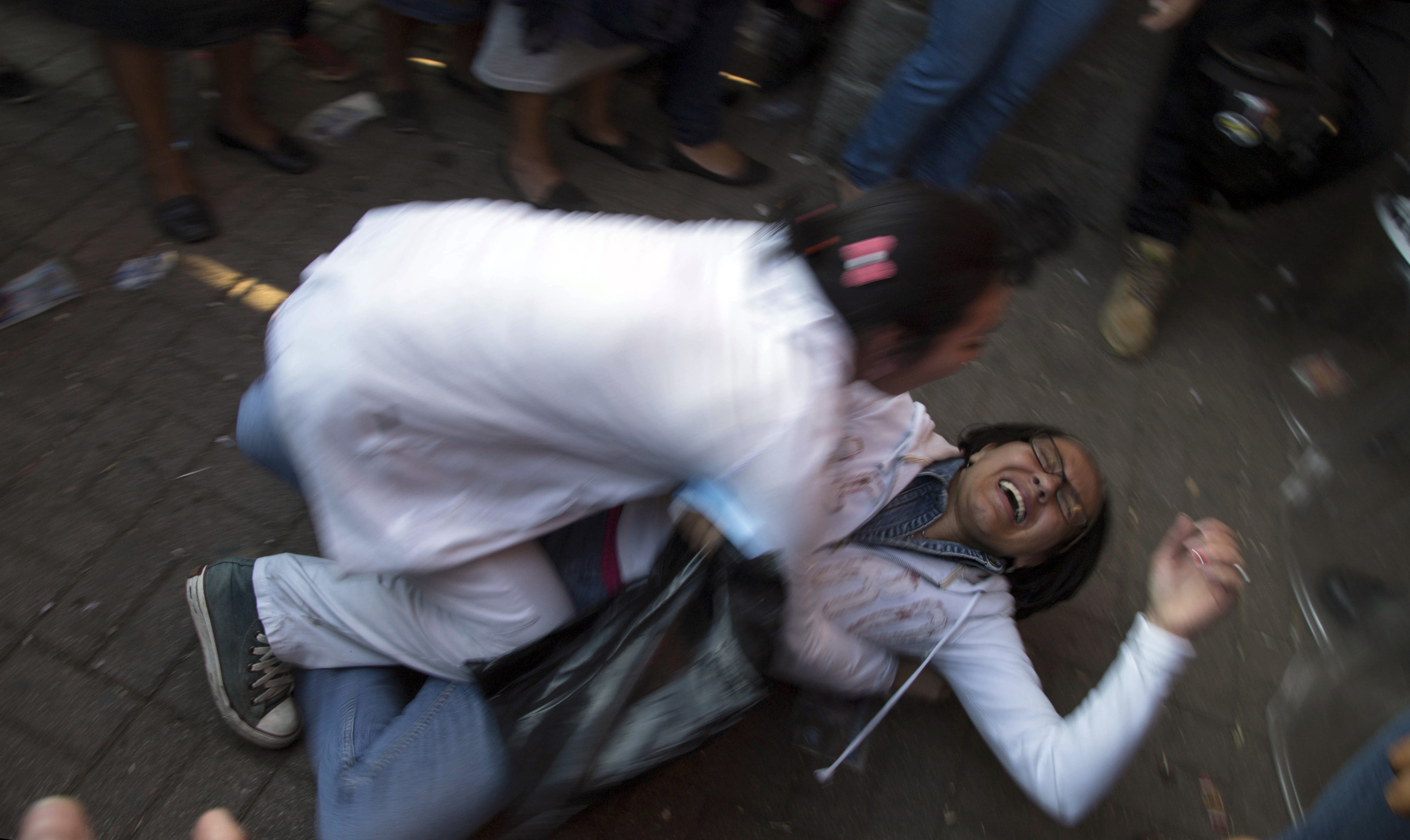A woman who learned her child died in a fire is held by her sister outside the children's shelter Virgin of the Assumption Safe Home, in San Jose Pinula, Guatemala on March 8, 2017. (AP Photo/Luis Soto)