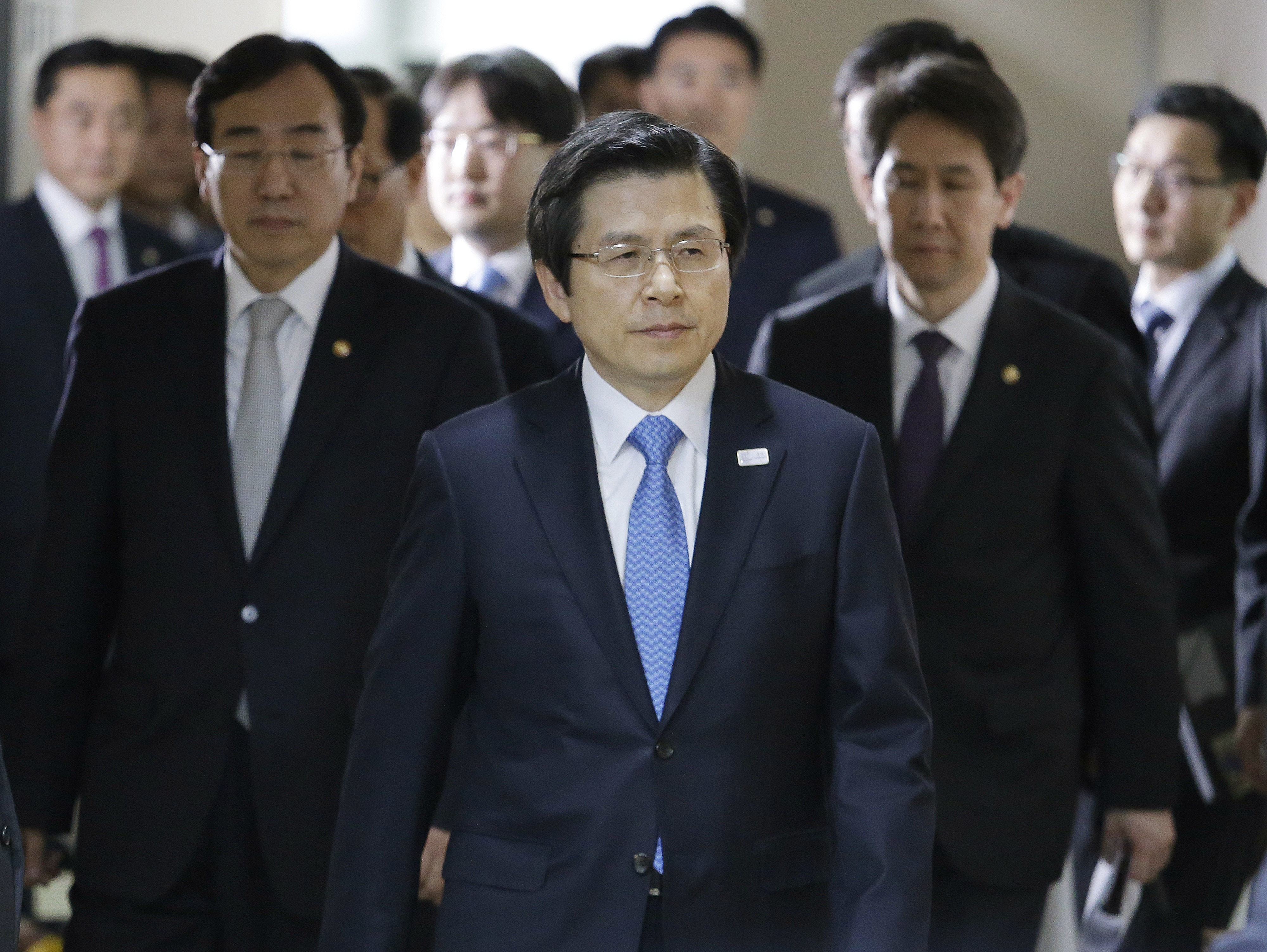 South Korean acting leader and Prime Minister Hwang Kyo-ahn, center, arrives to hold a press conference at the government complex in Seoul, South Korea on March 10, 2017. (AP Photo/Ahn Young-joon)