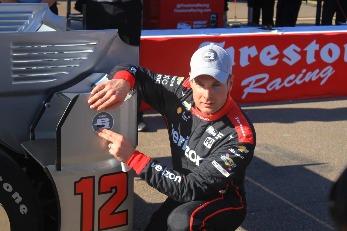 Will Power applies the Verizon P1 pole award sticker to the #12 Penske Dallara-Chevrolet after winning the pole for the IndyCar Firestone Grand Prix of St. Petersburg, March 11, 2017. (Chris Jasurek/Epoch Times)