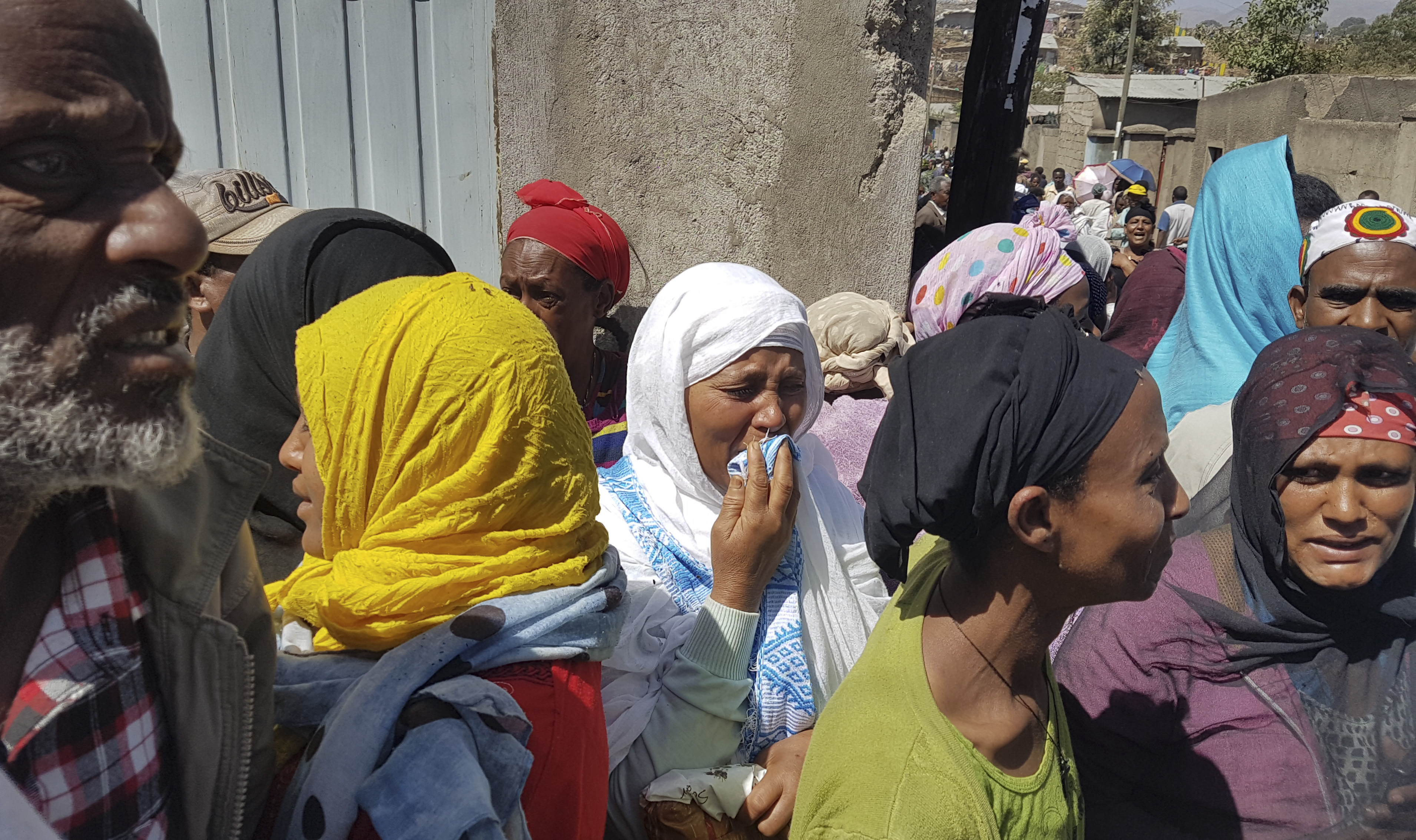 Residents of the area display their grief as bodies are recovered at the scene of a garbage landslide on the outskirts of the capital Addis Ababa, Ethiopia on March 12, 2017. (AP Photo/Elias Meseret)