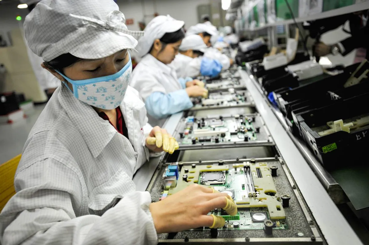 Chinese workers assemble electronic components at the factory of the technology giant Foxconn in Shenzhen, Guangzhou Province, in 2010. (AFP/AFP/Getty Images)