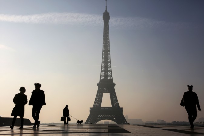  People walk on the Parvis des Droits de l'Homme square near the Eiffel tower in Paris on March 13, 2017. (Ludovic Marin/AFP/Getty Images)
